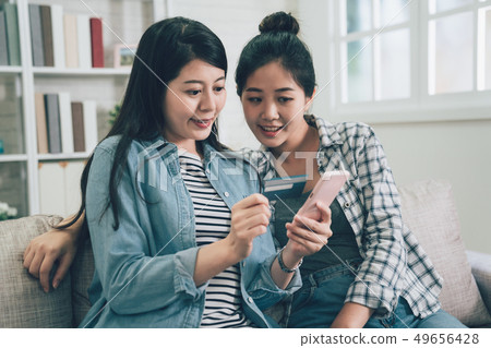 asian women using cellphone online payment asian women using cellphone online payment 49656428