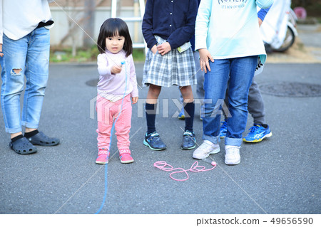 Toddler playing outside Toddler playing outside 49656590