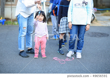 Toddler playing outside 49656591
