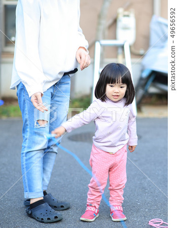 Toddler playing outside 49656592