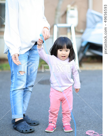 Toddler playing outside Toddler playing outside 49656593