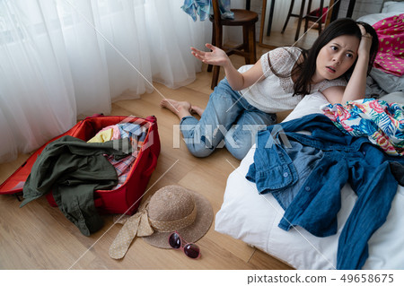 tired asian woman sit on floor near bed clothes tired asian woman sit on floor near bed clothes 49658675