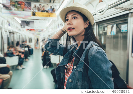woman commuter taking journey in public train woman commuter taking journey in public train 49658921