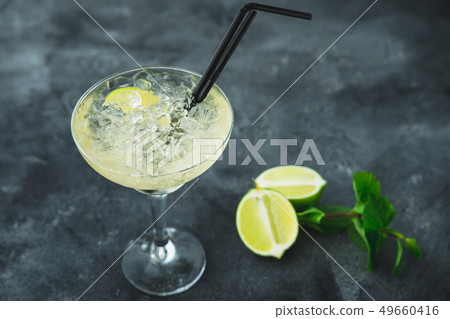 Mojito cocktail in glass and lime fruit on a table 49660416