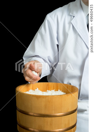 In front of the board holding a shari 49660435