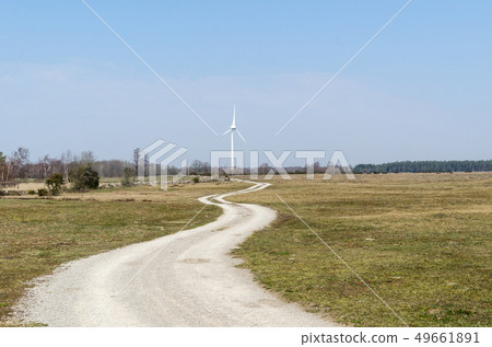 Winding country road leading to a windmill 49661891