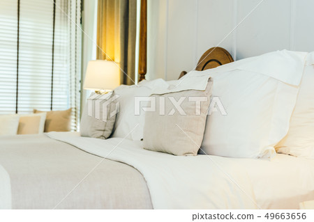 White pillow on bed decoration in beautiful luxury bedroom interior 49663656