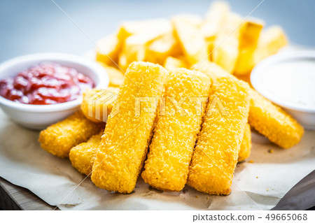 Fish finger and french fries or chips with tomato ketchup and mayonnaise sauce Fish finger and french fries or chips with tomato ketchup and mayonnaise sauce 49665068
