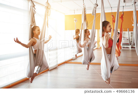 group of people engaged in a class of yoga Aero in 49666136