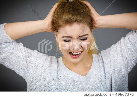 Unhappy woman screaming and yelling in pain 49667376