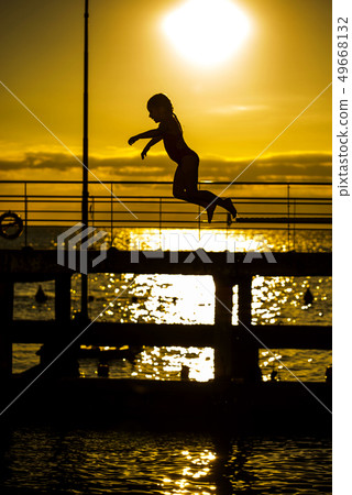 Little girl jumping into the sea Little girl jumping into the sea 49668132