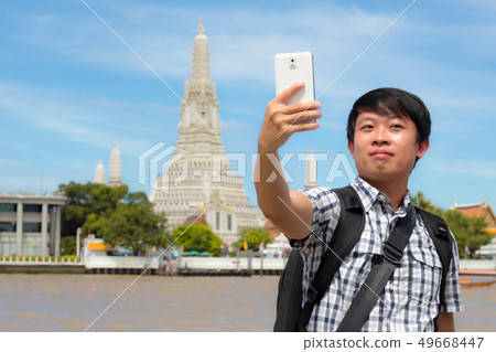 Tourists holding a mobile phone to take pictures 49668447