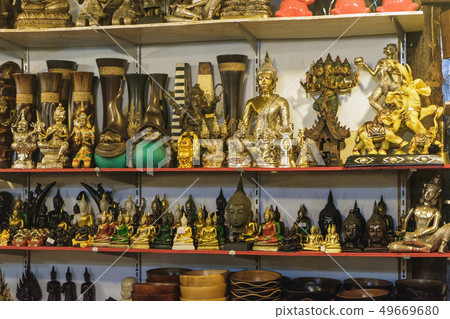 Buddhist statuettes and souvenirs at night market 49669680