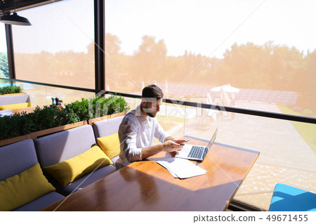 Real estate agent  talking by smartphone and working with laptop 49671455
