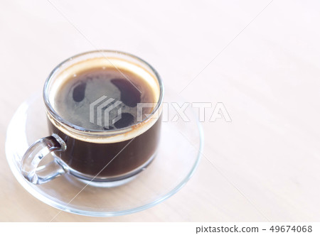 Closeup glass of hot americano coffee on wood Closeup glass of hot americano coffee on wood 49674068
