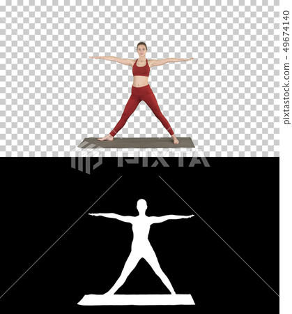 Woman practicing yoga, standing in Extended Side Angle exercise, Utthita parsvakonasana pose, Alpha 49674140