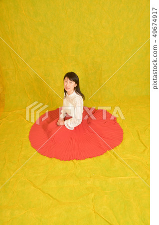 Studio shot portrait of dark-haired woman in red skirt 49674917