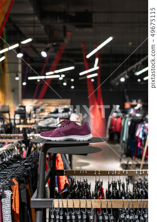 Modern clothes shop with large selection of different wear and shoes Modern clothes shop with large selection of different wear and shoes 49675115