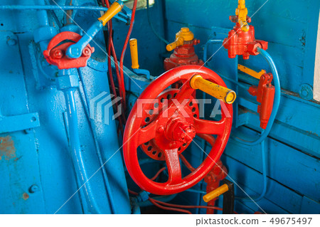Cab in the old train locomotive in blue and red colors with manual control 49675497
