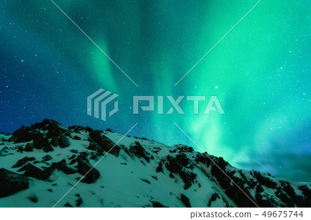 Aurora borealis above the snow covered mountain Aurora borealis above the snow covered mountain 49675744