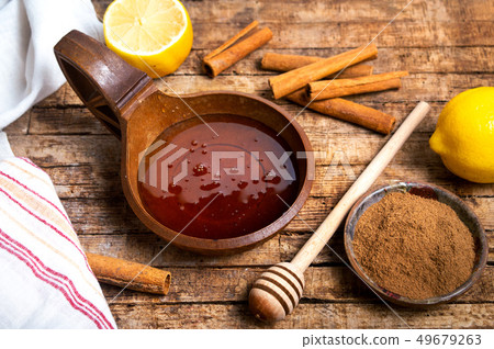 Honey and cinnamon on a wooden table 49679263