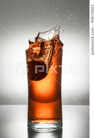 glass with ice and liquid splash glass with ice and liquid splash 49679883