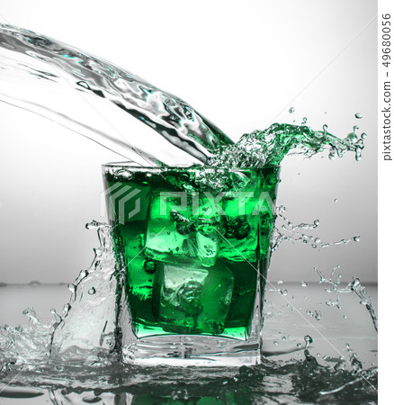 glass with ice and liquid splash 49680056