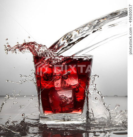 glass with ice and liquid splash 49680057