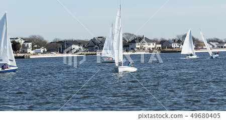 Small sailboats during a winter regatta 49680405