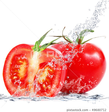 fresh tomatoes falling in water 49680712