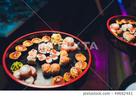 A large tray of sushi on New Year's party. A large tray of sushi on New Year's party. 49682481