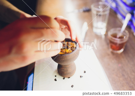 The process of cooking shisha, hookah bowl. The process of cooking shisha, hookah bowl. 49683353