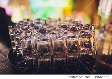 Empty shot glasses waiting on the counter for the party to start. Empty shot glasses waiting on the counter for the party to start. 49683356