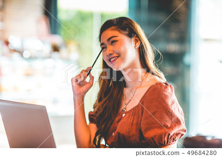 woman working with computer laptop and thinking to woman working with computer laptop and thinking to 49684280