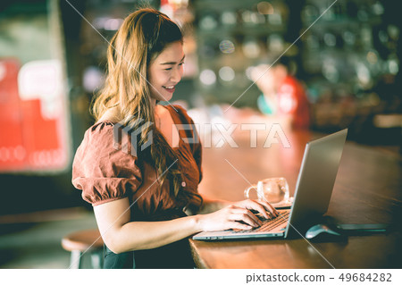 woman working with computer laptop and thinking to woman working with computer laptop and thinking to 49684282