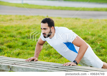 Fitness. Push-up exercise fitness man training arms muscles at outdoor gym 49684749