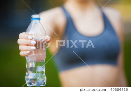 Fitness. Woman hand holding drinking water bottle Fitness. Woman hand holding drinking water bottle 49684816