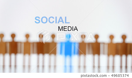 Social media sign above line of toy human figures 49685374
