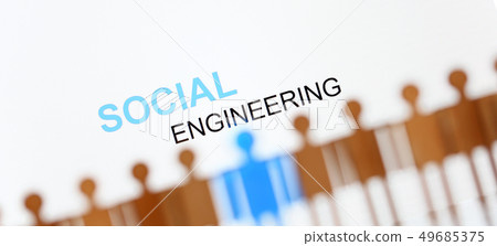 Social engineering sign above line of toy human figures 49685375