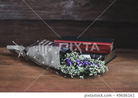 Still life text Book with Flower bouquet on wood Still life text Book with Flower bouquet on wood 49686161