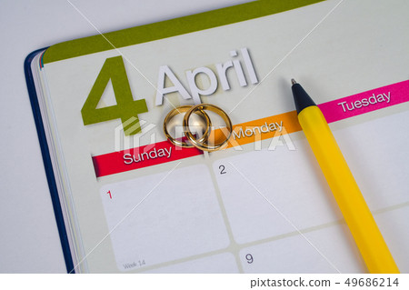 Gold Wedding ring on calendar planning or office 49686214