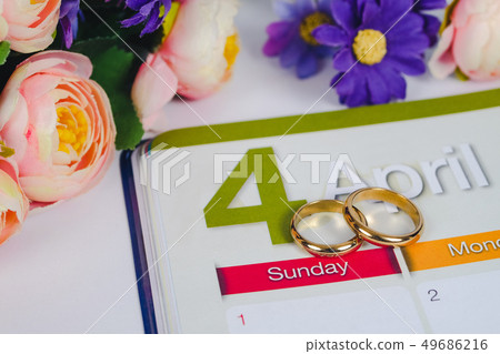 Gold Wedding ring on calendar planning or office 49686216