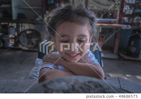 a boy wear black tee shirt watching his mobile a boy wear black tee shirt watching his mobile 49686573
