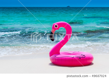 Pink rubber life ring on the beach. Pink rubber life ring on the beach. 49687024