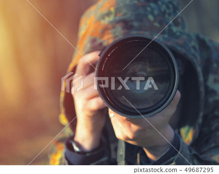 Wildlife, nature man photographer in camouflage Wildlife, nature man photographer in camouflage 49687295