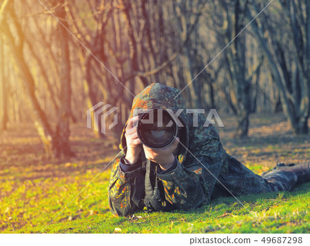 Wildlife, nature man photographer in camouflage 49687298
