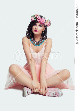 Beautiful model wearing pink dress, sneakers Beautiful model wearing pink dress, sneakers 49688028
