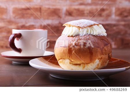 Swedish Semla, traditional Shrove bun, consists of light wheat bread with almond paste and whipped 49688269
