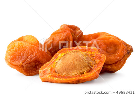 Dried apricots with a bone close-up on a white Dried apricots with a bone close-up on a white 49688431