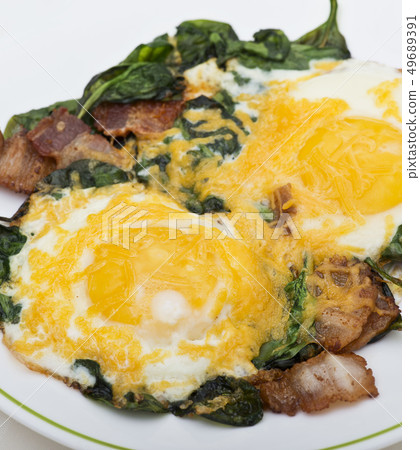 Keto diet breakfast with  eggs, spinach and bacon 49689391